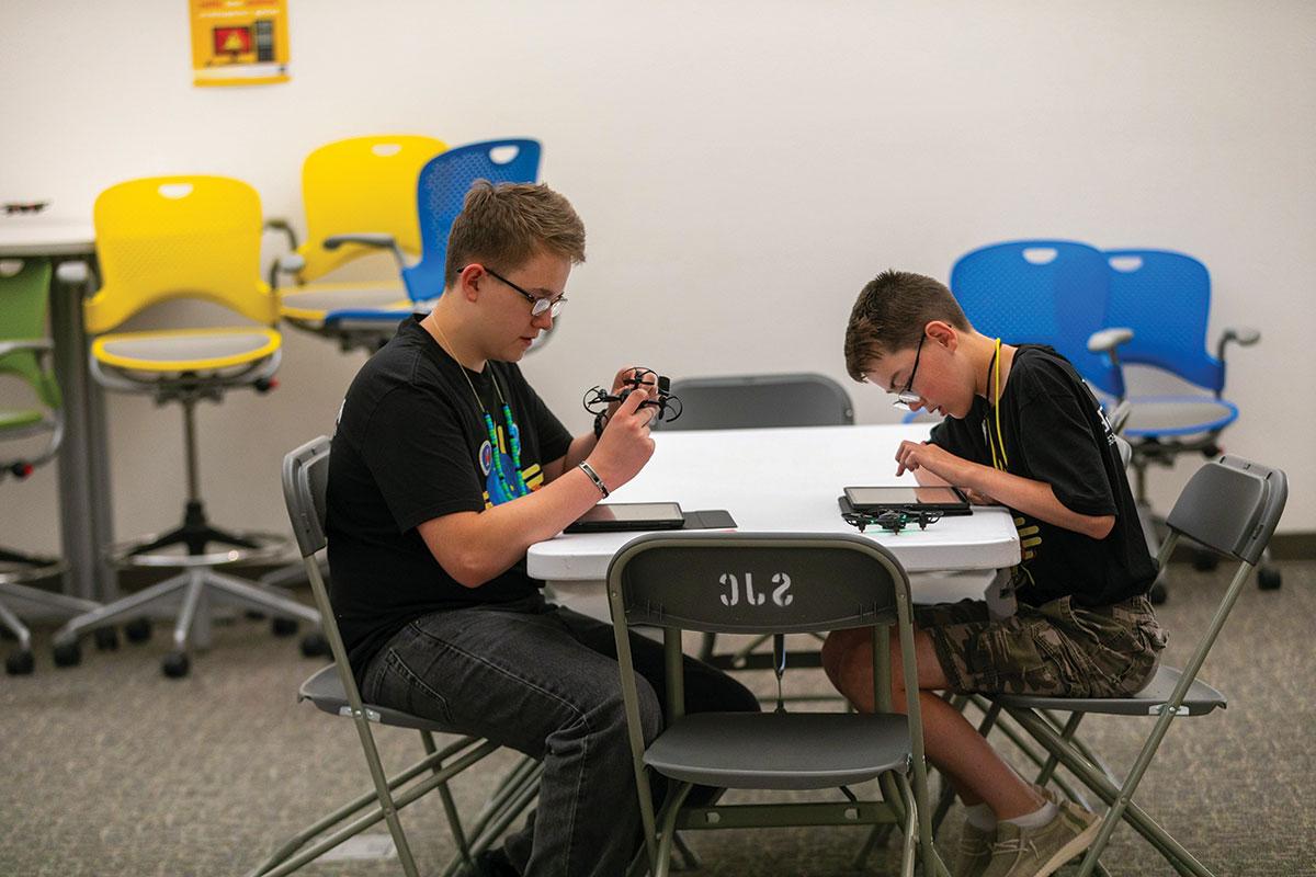 Two students sitting at a table in the GenCyber Program