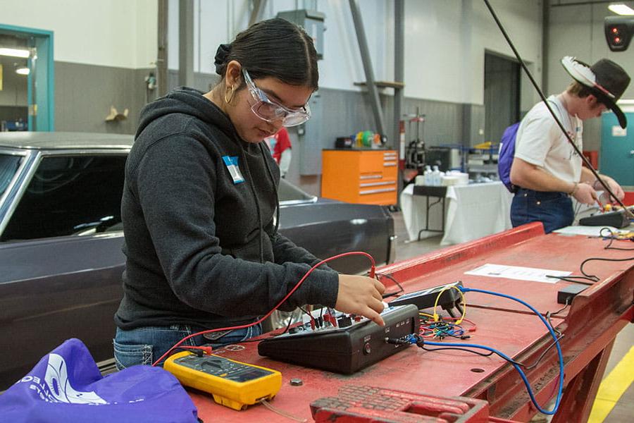 Two 太阳集团娱乐场登陆网站 students using diagnostic tools in the automotive repair shop